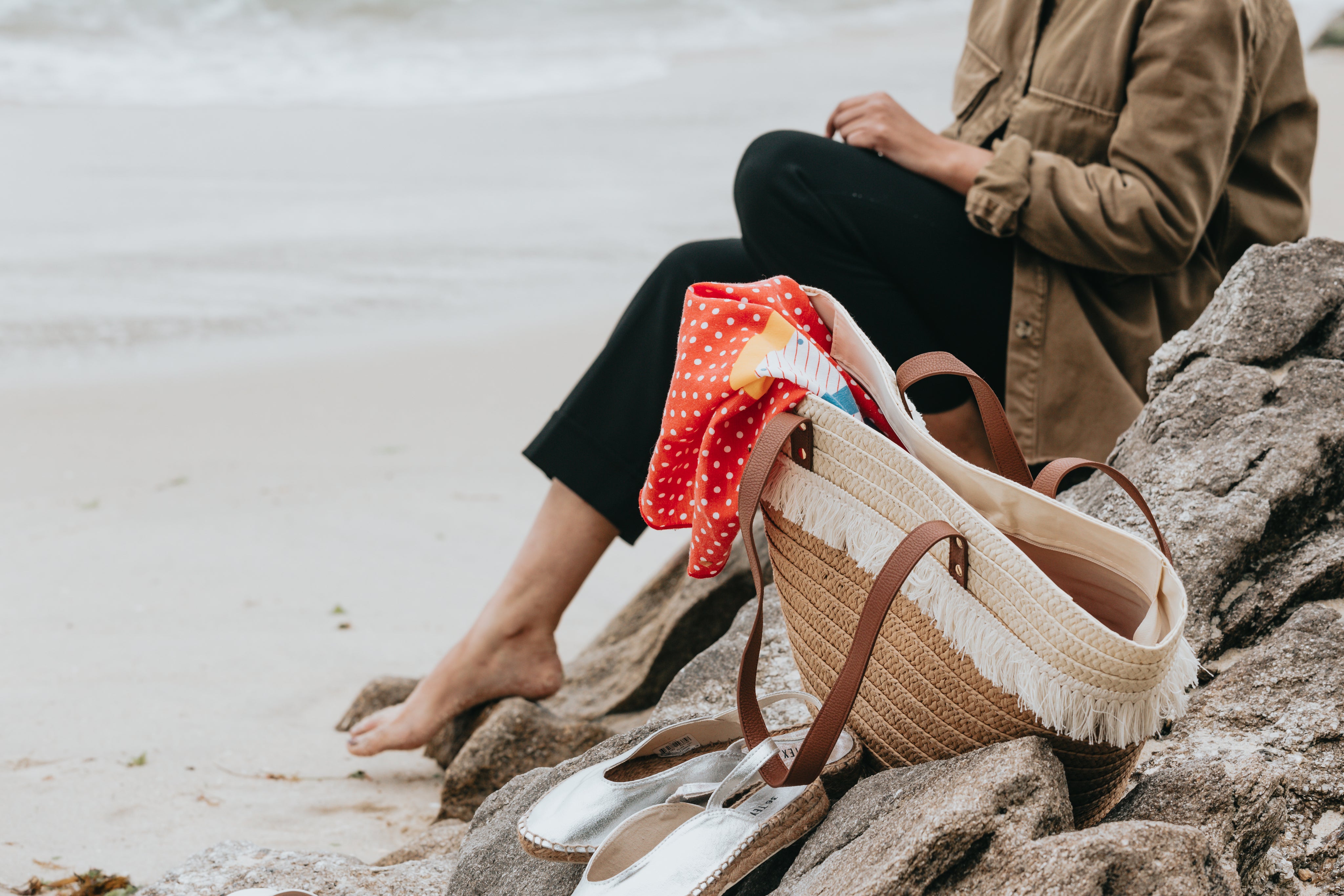 sitting-behind-a-wicker-beach-bag-on-rockys-by-the-beach.jpg